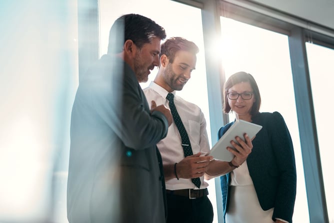 group of businesspeople using tablet